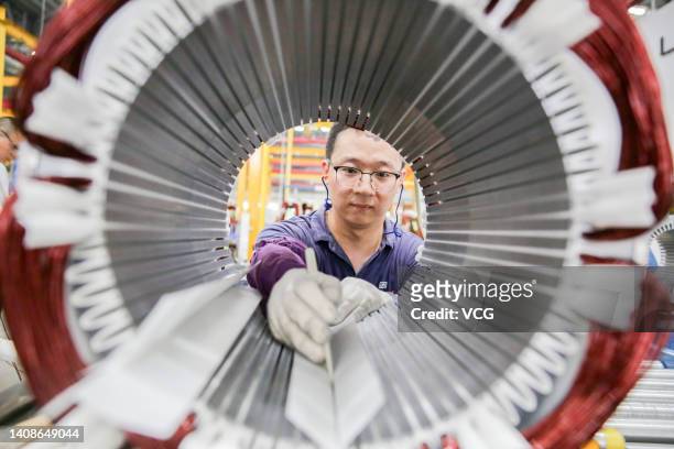 An employee works on the production line of motors at Weg Electric Motor Manufacturing Co., Ltd. On July 14, 2022 in Nantong, Jiangsu Province of...
