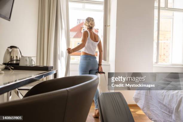 young woman checking in hotel room - leaving room stock pictures, royalty-free photos & images