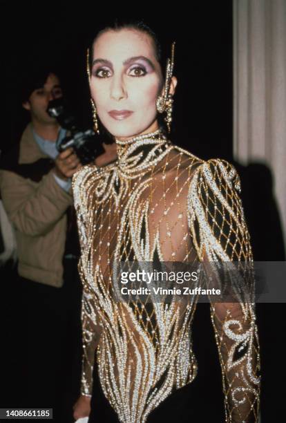 Cher wears a custom sequin black and sheer outfit by Bob Mackie at the Met Gala exhibition of "Costumes of Royal India" in New York City, United...