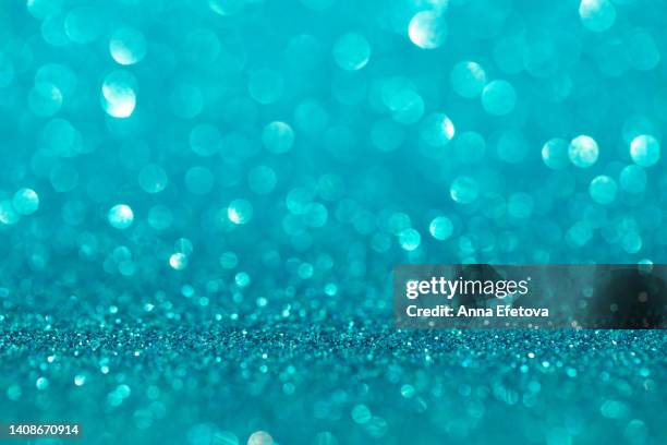 blue background made of sequins and lights. holiday concept. copy space for your design. selective focus - türkis stock-fotos und bilder