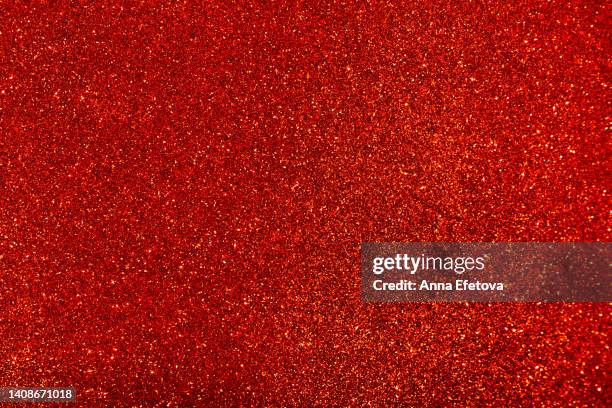 red background made of sequins and lights. holiday concept. copy space for your design. selective focus - glittering foto e immagini stock