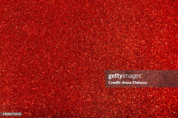 red background made of sequins and lights. holiday concept. copy space for your design. selective focus - red texture stockfoto's en -beelden