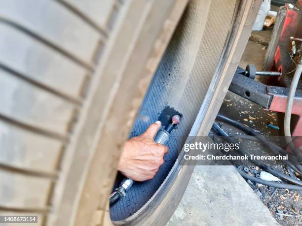 repairing a car tire (vehicle part) with grinder - lkw reifen stock-fotos und bilder