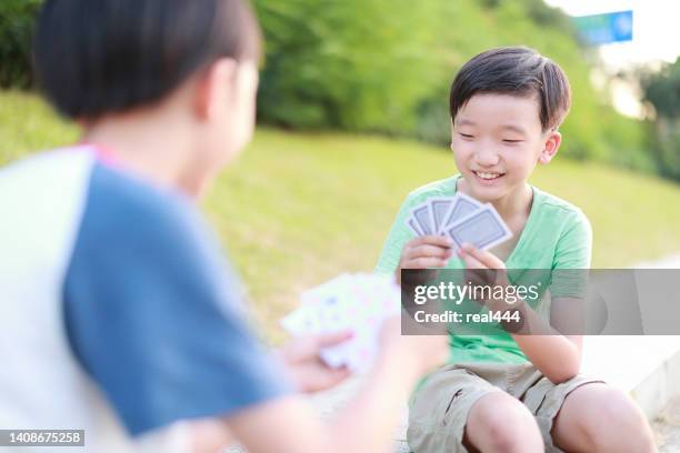 boy playing cards - bridge card game stock pictures, royalty-free photos & images