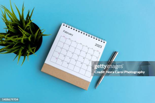 february 2023 desk calendar on blue background - february 1 stock pictures, royalty-free photos & images