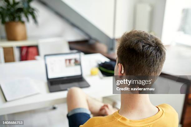 deaf teenage student doing homework - student behind laptop stock pictures, royalty-free photos & images