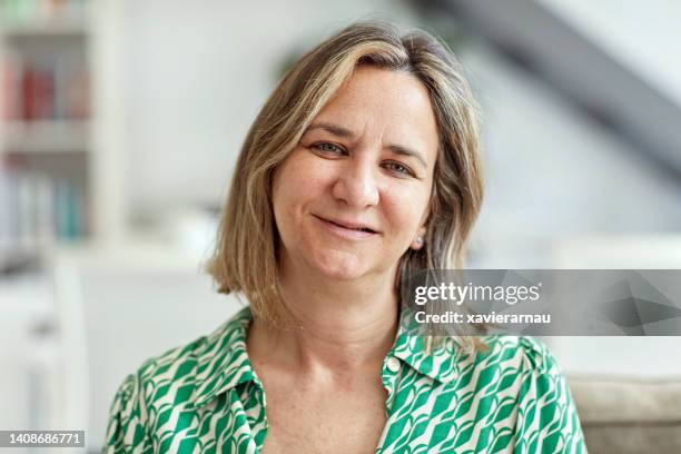 headshot of late 40s woman in family home - head cocked stock pictures, royalty-free photos & images