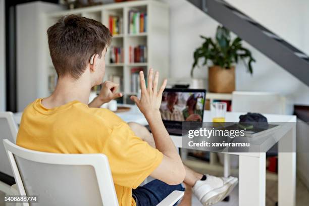 deaf family catching up during video call on laptop - hearing aids stock pictures, royalty-free photos & images