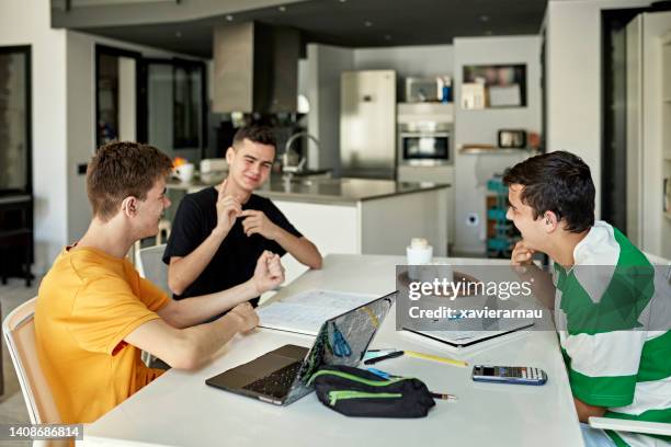 boys sitting at dining table doing homework and signing - group of people using sign language stock pictures, royalty-free photos & images