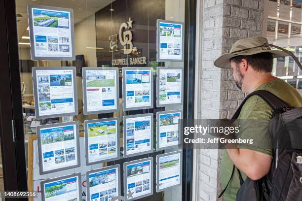 Punta Gorda, Florida, Coldwell Banker, real estate office, man looking at property listings and homes for sale .
