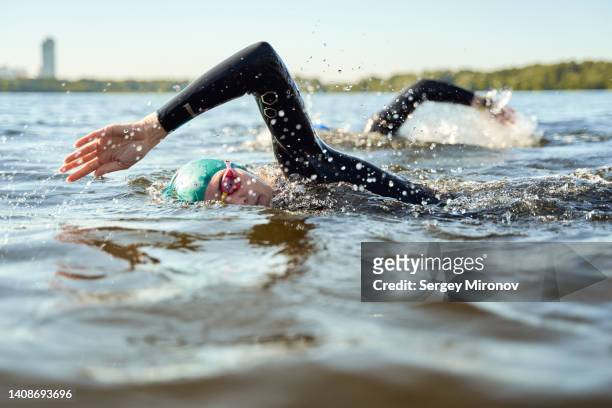 swimmers in open water. - people swim river stockfoto's en -beelden