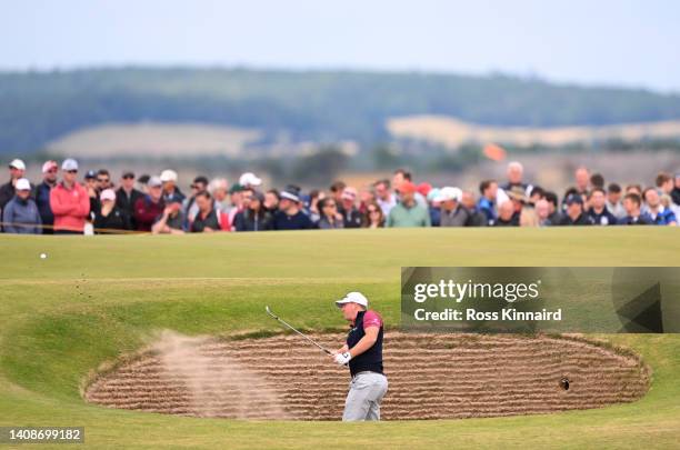 Tom Hoge of the United States plays a bunker shot for his third shot on the eleventh hole during Day One of The 150th Open at St Andrews Old Course...