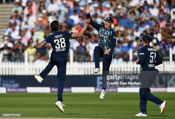 Reece Topley of England celebrates with Jason Roy of England after taking the wicket of Shikhar Dhawan of India during the 2nd Royal London Series...