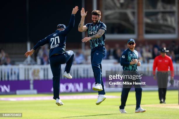 Reece Topley of England celebrates with Jason Roy after dismissing Shikhar Dhawan of India during the 2nd Royal London Series One Day International...