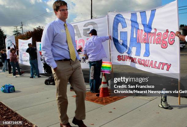 Brent Allen, owner and operator of the new Chick-fil-A franchise, walks past gay rights activists protesting the grand opening of his restaurant in...