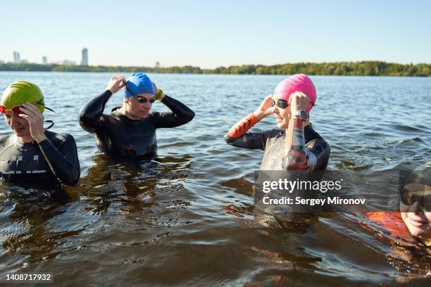 portrait group of swimmers in open water. - neoprene fotografías e imágenes de stock