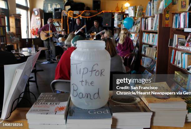 The tip jar for Bundy Browne and the Expresso Rhythm Section is placed on books for sale at the San Gregorio General Store in San Gregorio, Calif. On...
