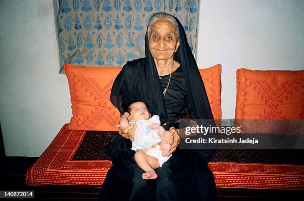 great grandmother holding her great grandson - kiratsinh jadeja stock-fotos und bilder