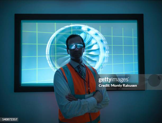 portrait of engineer standing in front of engine part on 3d screen - corporate dark portrait stock-fotos und bilder