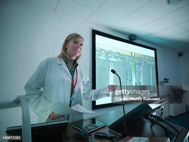 scientist using presentation on smart board for lecture - interaktives whiteboard stock-fotos und bilder