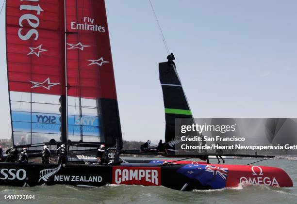 Emirates Team New Zealand crew members raise the front sail for a training session in San Francisco, Calif. On Tuesday, July 2, 2013. Competition for...