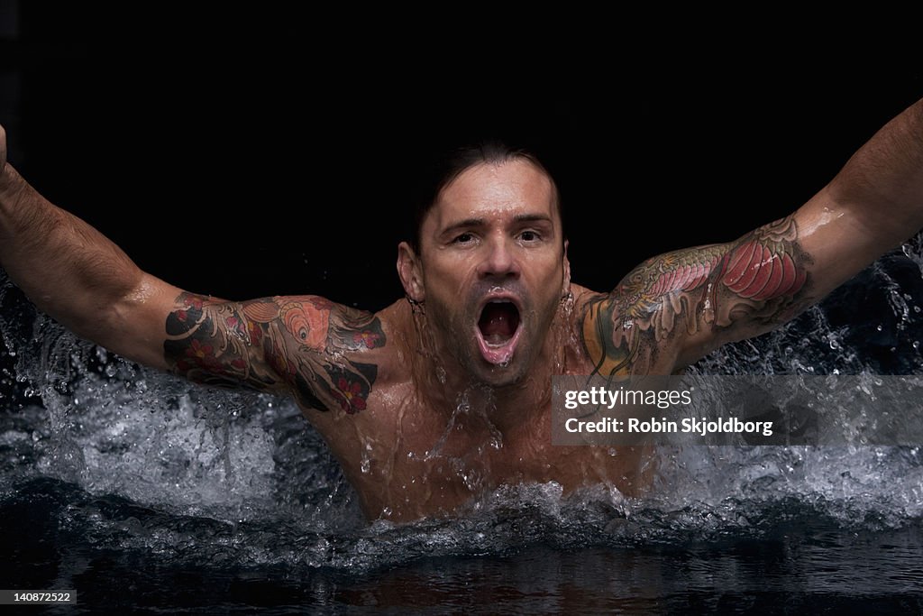 Man splashing in swimming pool