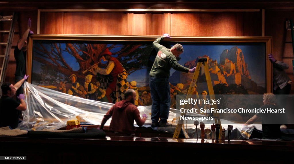 Protective wrapping is removed by an installation crew before hanging the Pied Piper of Hamelin painting in its original location behind the bar at the Palace Hotel in San Francisco, Calif. on Thursday, Aug. 22, 2013. The historic work by Maxfield Parrish