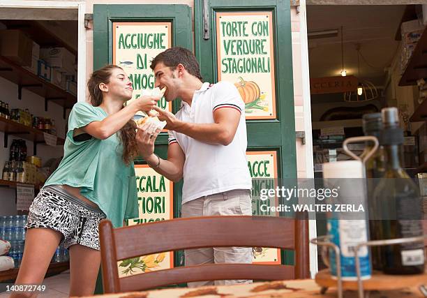 couple sharing food at cafe - camogli bildbanksfoton och bilder