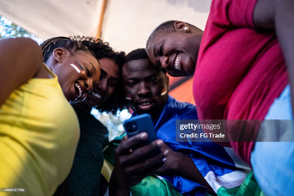 Friends watching sports on the mobile phone
