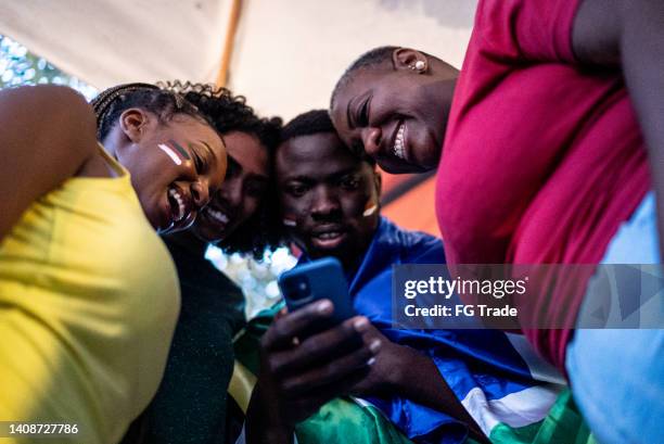 friends watching sports on the mobile phone - telephone game stock pictures, royalty-free photos & images