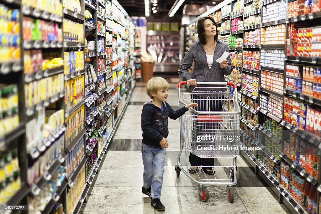 Woman grocery shopping with son
