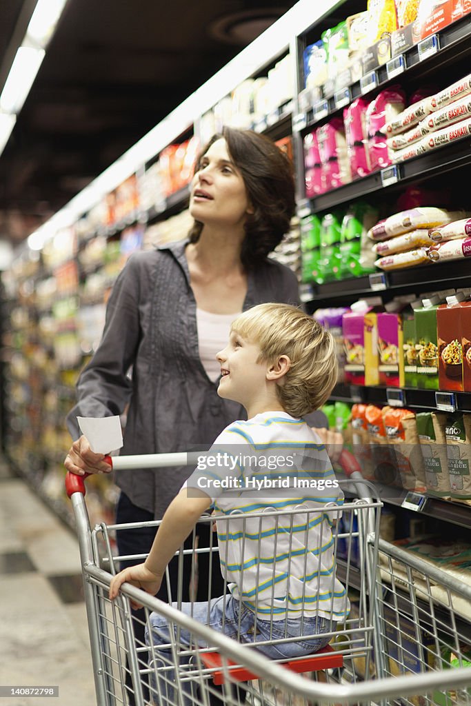 Woman grocery shopping with son