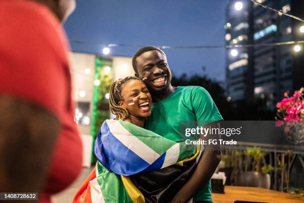 sports fan friends talking and having fun outdoors - south africa flag stock pictures, royalty-free photos & images