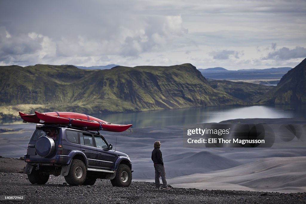 Man with Jeep admiring rural landscape