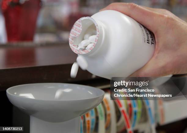 Pharmacist Benson Toy shakes ibuprofen into a pill counter at the Marin Medical Pharmacy in San Rafael, Calif. On Tuesday, Dec. 24, 2013. Toy is...