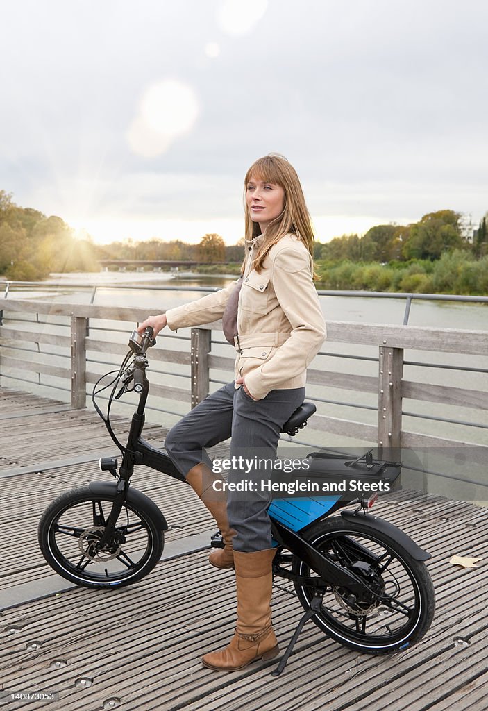 Woman with bike on wooden walkway