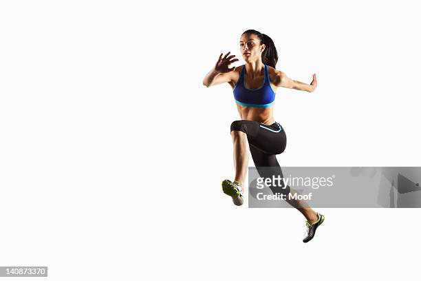 athlete running in mid air - determination athlete stock pictures, royalty-free photos & images