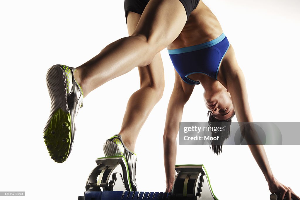 Athlete putting feet into starting block