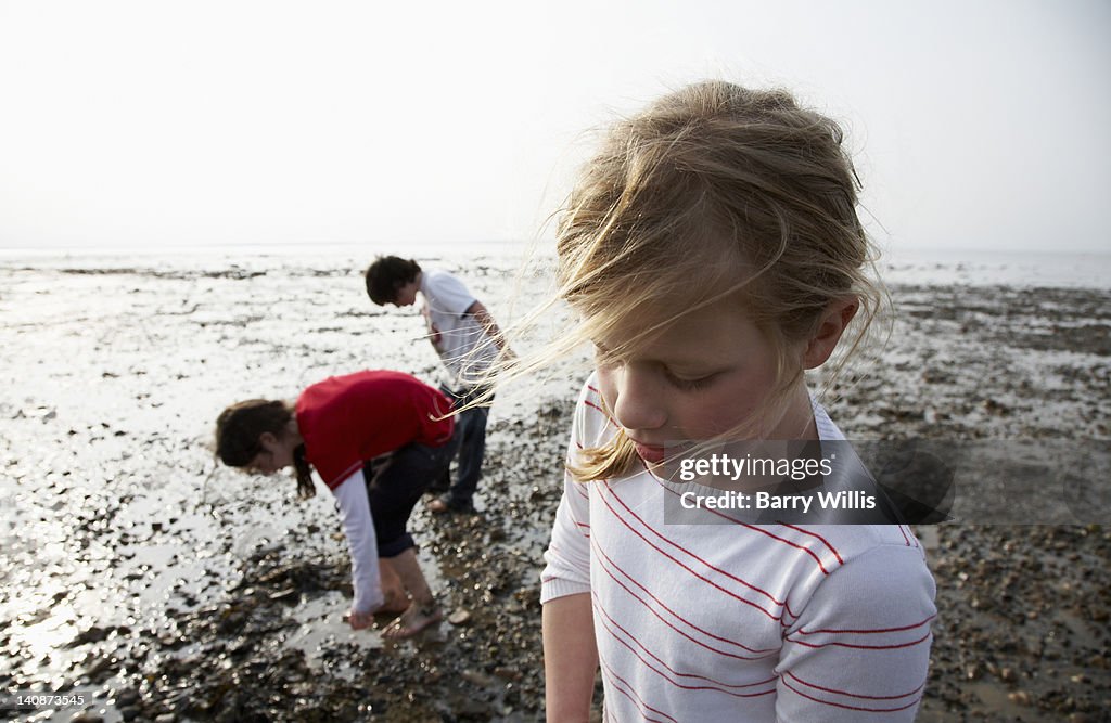 Children playing on rocky beach