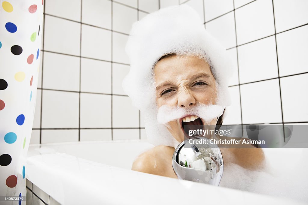 Boy playing in bubble bath