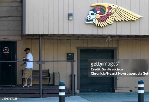 An unidentified man enters the Hell's Angels clubhouse after a pre-dawn raid by FBI agents in San Francisco, Calif. On Wednesday, May 14, 2014.