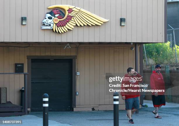 Unidentified men leave the Hell's Angels clubhouse after a pre-dawn raid by FBI agents in San Francisco, Calif. On Wednesday, May 14, 2014.