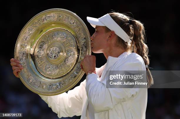 Elena Rybakina of Kazakhstan celebrates with the trophy after victory against Ons Jabeur of Tunisia during the Ladies' Singles Final match on day...