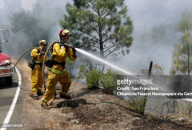 Napa County fire crew moveis in to extinguish flames on Butts Canyon Road near Aetna Springs, Calif. On Wednesday, July 2, 2014. The Butts Fire has...
