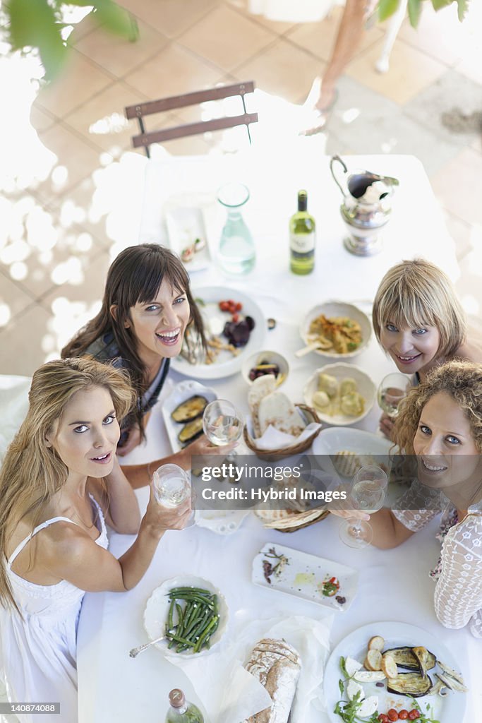 Women eating at table outdoors