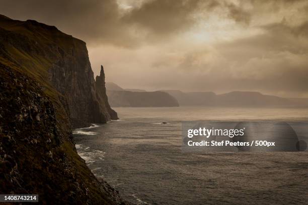 scenic view of sea against sky during sunset,faeroe islands,denmark - stef peeters stockfoto's en -beelden