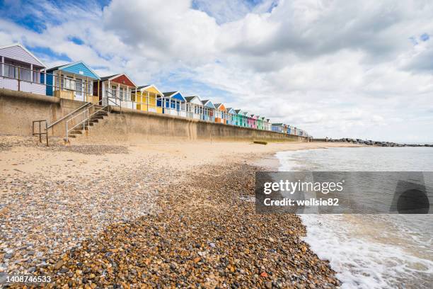 southwold beach huts next to the pier - southwold stock pictures, royalty-free photos & images