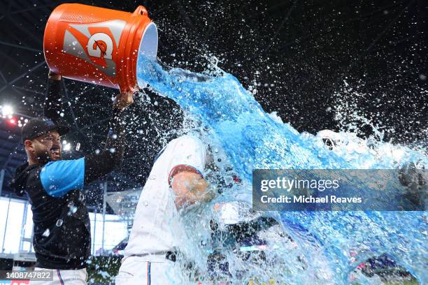 Pablo Lopez of the Miami Marlins dumps Gatorade on Brian Anderson after he hit a walk-off triple against the Pittsburgh Pirates during the eleventh...