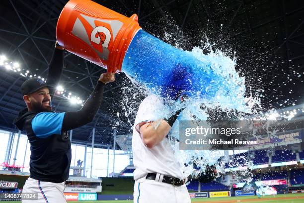 Pablo Lopez of the Miami Marlins dumps Gatorade on Brian Anderson after he hit a walk-off triple against the Pittsburgh Pirates during the eleventh...