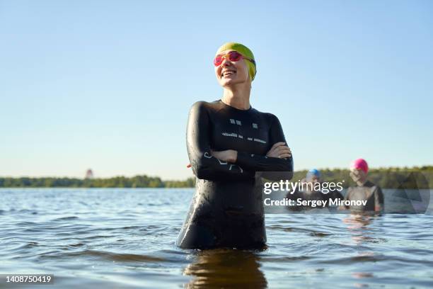 portrait of cheerful swimmer - open water swimming stock-fotos und bilder